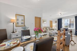 a dining room and living room with a table and chairs at 2 Bed in Seahouses oc-86092 in North Sunderland