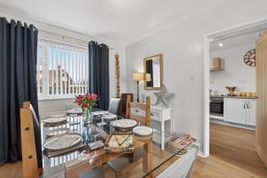 a dining room and living room with a glass table at 2 Bed in Seahouses oc-86092 in North Sunderland +24 photos