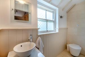 a white bathroom with a sink and a window at 4 Bed in Helmsley oc-y039 in Helmsley +26 photos