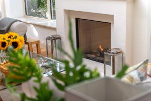 a fireplace in a living room with a fire place at The Old Mill House Experience in Dalkeith