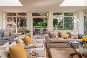 a large living room with couches and windows at The Old Mill House Experience in Dalkeith