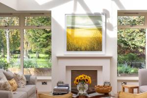 a living room with a painting on the wall and a fireplace at The Old Mill House Experience in Dalkeith +92 photos