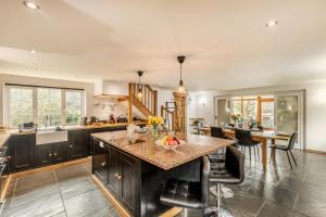 a kitchen with a island with a bowl of fruit on it at 3 Bed in Holsworthy oc-29125 in Thornbury