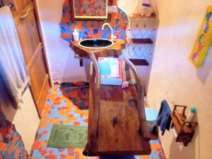 a doll house bathroom with a sink and a toilet at Pousada Kite Guajiru in Itarema