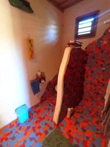 a bedroom with a bed covered in legos at Pousada Kite Guajiru in Itarema