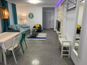 a living room with a couch and a table at PP Apartments Deluxe in Năvodari +1 photo
