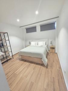 a bedroom with a bed and a wooden floor at Las vegas in Alcorcón