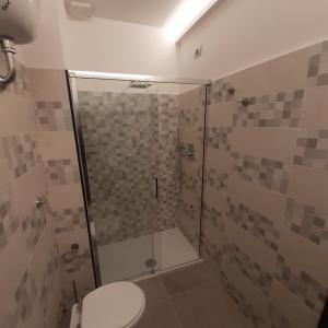 a bathroom with a glass shower with a toilet at Angela's house in Sulmona