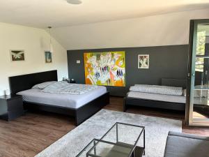 a bedroom with two beds and a glass table at Ferienwohnung Kolb in Issum