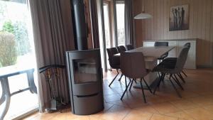 a dining room with a fireplace and a table and chairs at Wildgans Classic 247 in Mirow