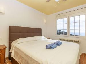 a bedroom with a bed with two blue towels on it at Holiday Home Floramar by Interhome in Lloret de Mar