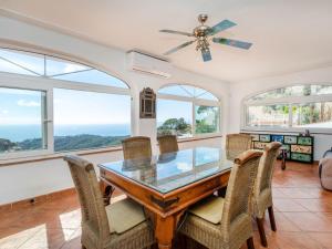 a dining room with a glass table and chairs and windows at Holiday Home Floramar by Interhome in Lloret de Mar