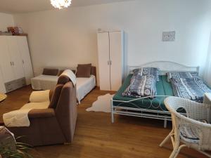 a living room with a bed and a couch at Appartement in Hannover