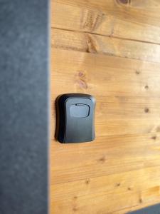 a black object sitting on a wooden floor at Woodhouse in Bijelo Polje