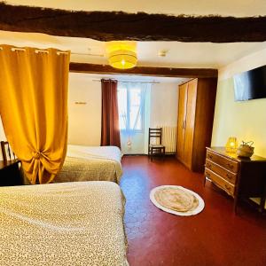 a bedroom with two beds and a window at Hôtel Restaurant La Forge in Castellane +8 photos