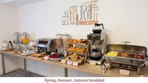a bakery counter with pastries and other food items on it at Tintagel Arms Bed and Breakfast in Tintagel