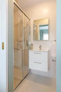 a bathroom with a shower and a sink and a mirror at Sea Mist Guesthouse in Galway +40 photos
