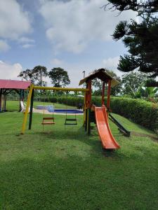 a playground with a slide in a park at Finca Montenegro Quindio in Montenegro