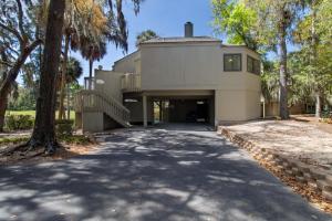 a house with a driveway leading to a garage at 611 Magnolia-Stella Maris in Edisto Island
