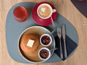 a plate of food with pancakes and a cup of coffee at Ristorante Le Rasole in Garda