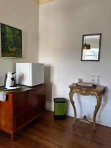 a room with a table and a microwave on a dresser at Gästehaus Flair in Mettlach +33 photos