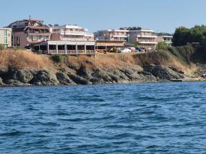 a group of houses on the shore of a body of water at Guest House Compass in Lozenets +93 photos