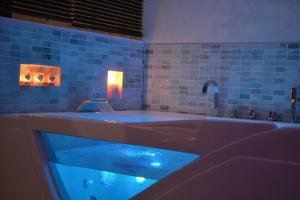 a bath tub with blue water in a bathroom at Suite hors du temps in Le Castellet