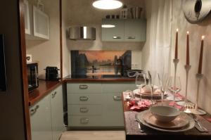 a kitchen with a table with plates and wine glasses at Suite hors du temps in Le Castellet