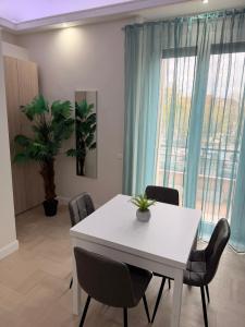 a dining room with a white table and chairs at Saraceno House G&P in Adrano