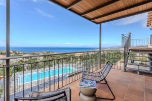 a balcony with a view of the pool and the ocean at Thalassori Villas in Agios Nikolaos +86 photos