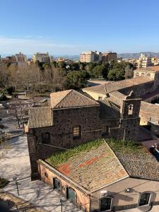 an old building with grass on the roof at Saraceno House G&P in Adrano