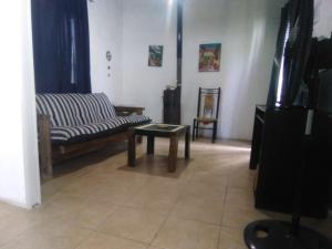 a living room with a couch and a coffee table at Mendoza Junín aceptamos tarjetas in Junín