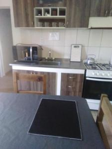 a kitchen with a stove and a counter top at Mendoza Junín aceptamos tarjetas in Junín +12 photos