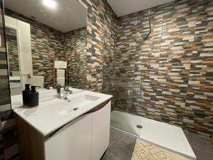 a bathroom with a white sink and a shower at Casas S. Dinis in Porto