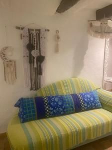 a couch sitting in a room with some curtains at Le PHoenix in Roquestéron +22 photos