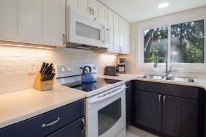 a kitchen with a sink and a stove top oven at 611 Magnolia-Stella Maris in Edisto Island