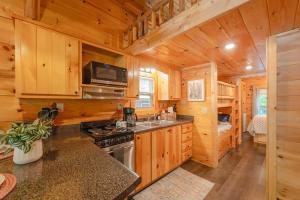 a kitchen with a stove and a sink in a cabin at Ani Cabin Tiny Home Bordered By National Forest in Chattanooga
