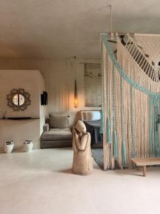 a toy dog sitting in a room with a bed at Casa Nikau Chic Getaway in El Cuyo in El Cuyo