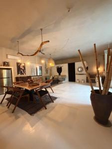 a living room with a wooden table and a couch at Casa Nikau Chic Getaway in El Cuyo in El Cuyo +23 photos