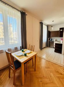 a kitchen and dining room with a table and chairs at Gdynia Abrahama 48 in Gdynia