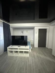 a living room with a large flat screen tv at Tower Apartments A6 in Năvodari
