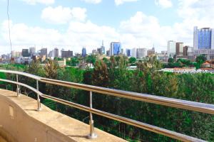 a view of a city skyline from a balcony at Emeli apartments in Nairobi