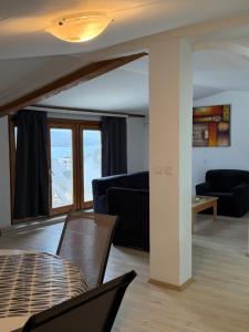 a living room with a couch and a table at Villa Fantasy Premium Lakeview in Ohrid