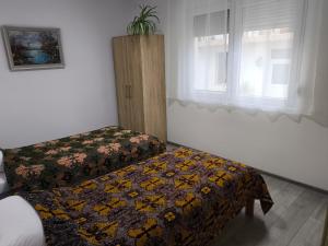 a bedroom with two beds and a window at Gorica in Negotin