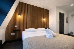 a bedroom with a bed with two pillows on it at Amsterdam Hotel in London