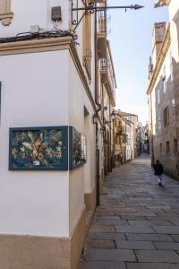 an alley with a painting on the side of a building at Casa Celsa-Barbantes in Santiago de Compostela