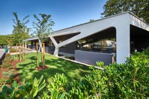 a modern house with a lawn in front of it at SUNNY Mobile Homes Bijela Uvala in Poreč