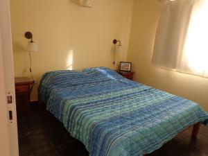 Кровать или кровати в номере Departamentos Los Tamariscos