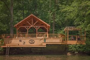 a wooden bridge over a body of water at Cherokee Ridge Cabin Near The Ocoee River in Ocoee