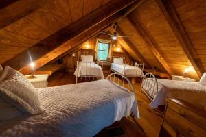 a attic bedroom with two beds in a room at Creek Crest Cabin Ocoee Riverside Cabin in Ocoee